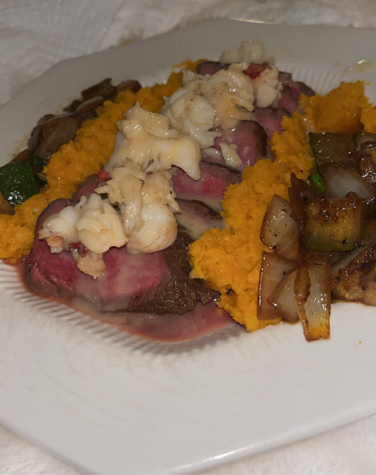 Steak & Lobster surf n turf W/ sweet potatoes topped with a lobster stock reduction