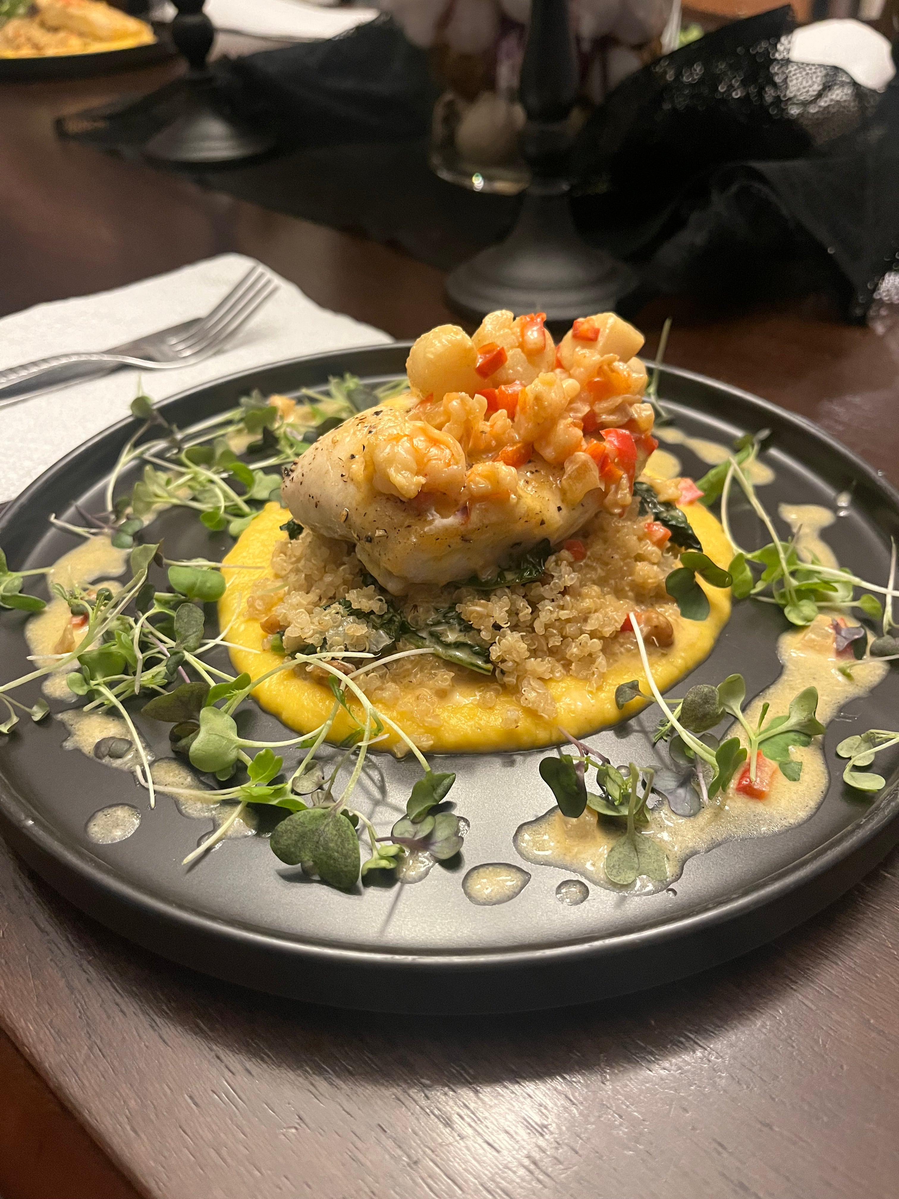 Halibut w/ roasted chick pea and kale quinoa and a butternut squash puree. Topped with a scallop and shrimp cream sauce