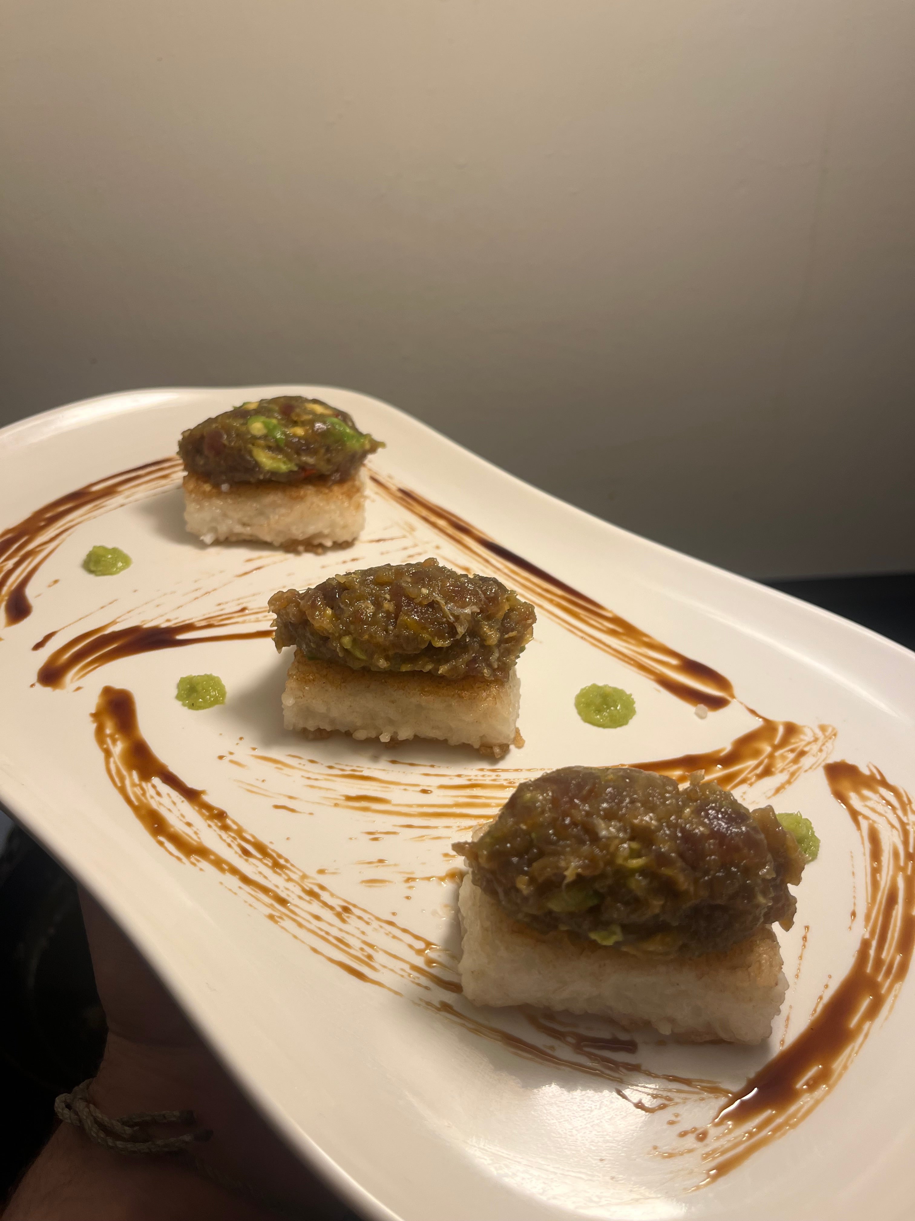 Tuna Tartar on Seared rice cake with wasabi and Spicy Soy reduction