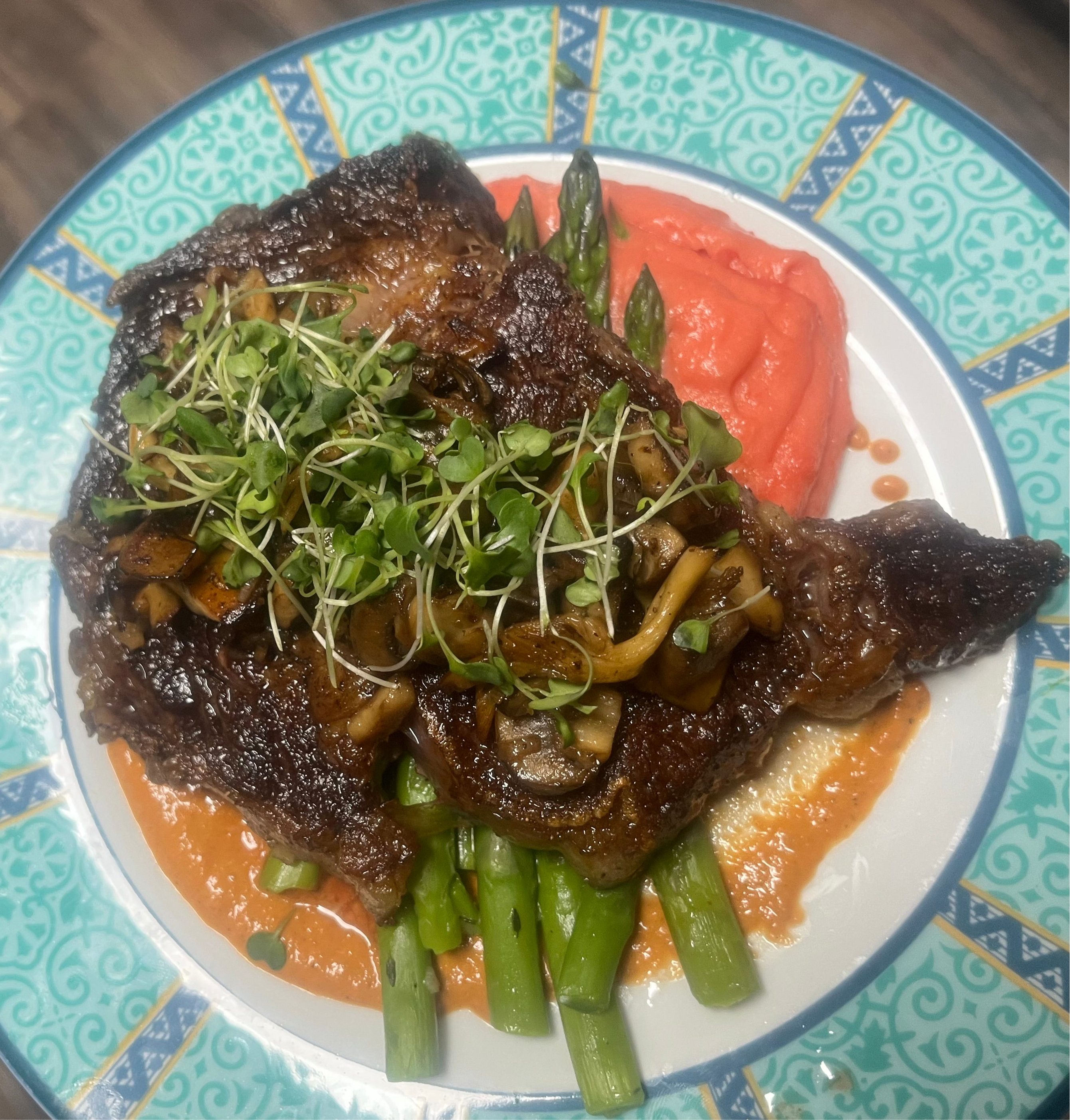 Dry-aged Ribeye w/ a beet Pomme Puree and asparagus topped with sautéed shallots & mushroom mix